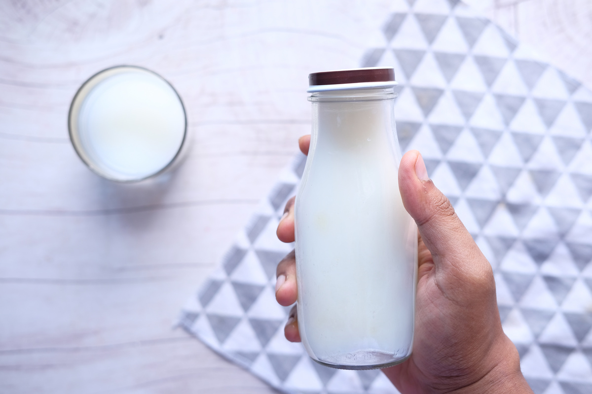 Top View Man Hand Holding Milk Bottle.